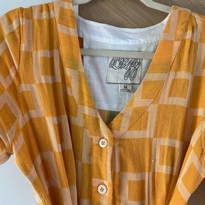 Ace & Jjg yellow print button down tie dress.